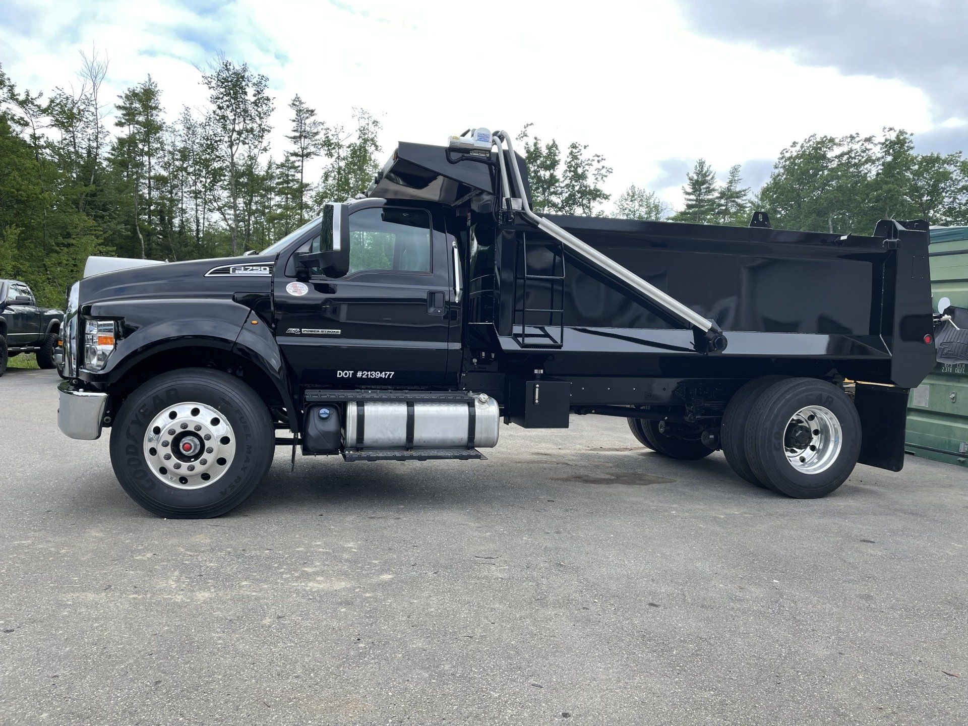 Black Ford F-650 dump truck repaired at Champion Auto Body